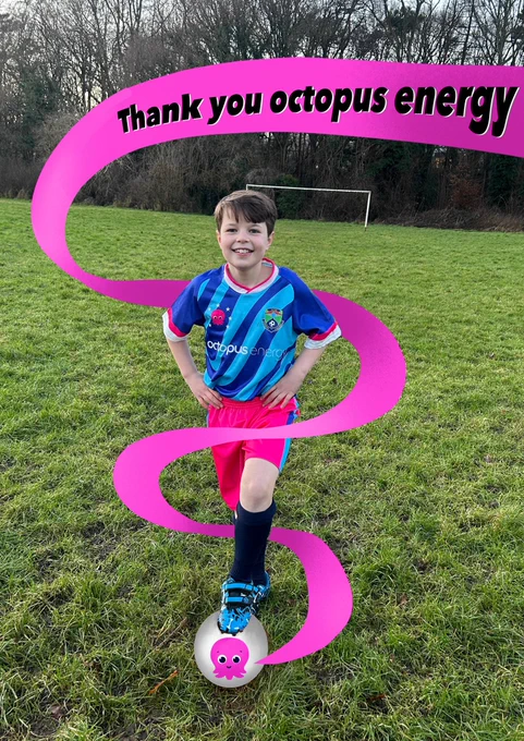 Boy wearing octopus energy football kit. Standing in a field with his foot on a ball with an octopus on it