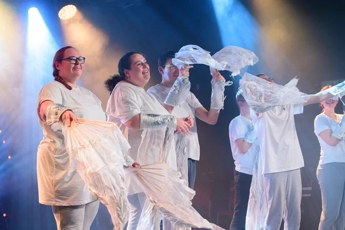 A group of adults dancers wearing white and silver perform a dance routine on stage at the Lincolnshire Sport & Physical Activity Awards.
