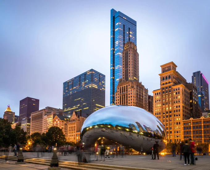 the chicago city downtown, with a snow covered mirror sculpture in the foreground