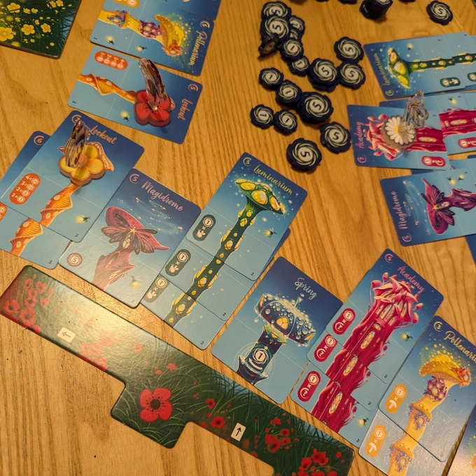 Close-up of the board game Fairy Ring. The game has components with flowers and mushrooms.