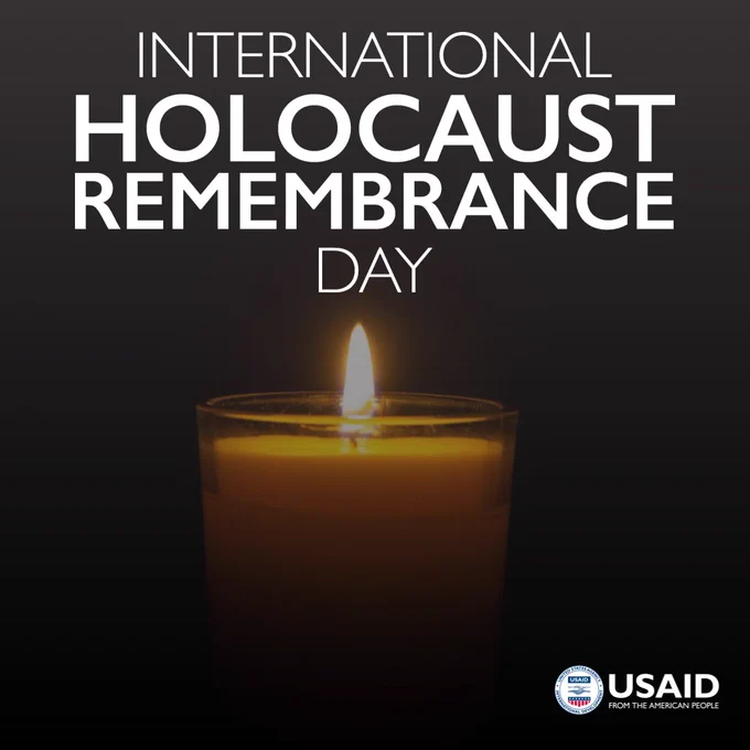 A photo of a single lit candle. Text atop image reads: International Holocaust Remembrance Day