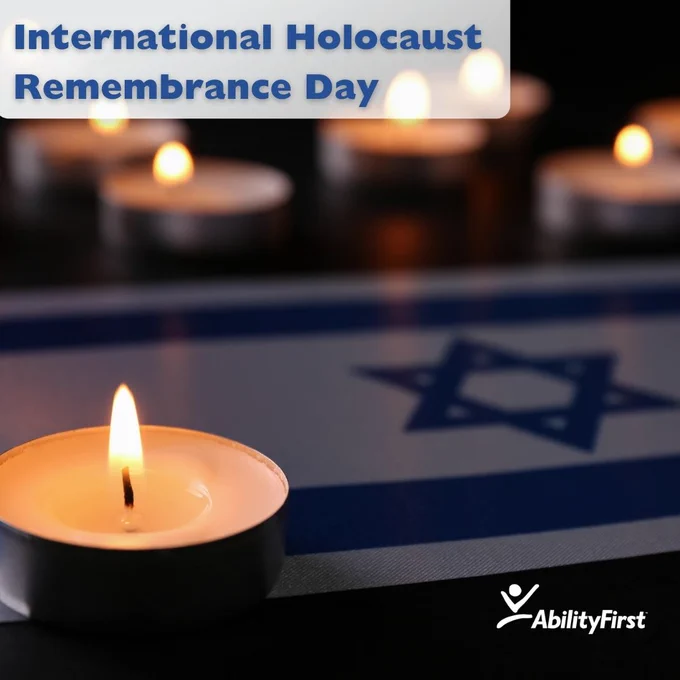Image commemorating International Holocaust Remembrance Day. A lit tealight candle is in focus, set against a background featuring the Israeli flag and additional lit candles, symbolizing reflection and remembrance. The AbilityFirst logo is displayed in the bottom-right corner.