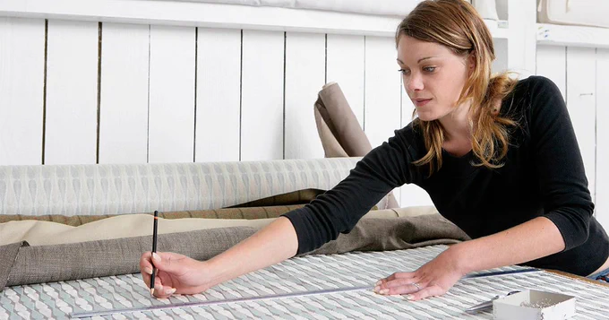 A women measuring fabric