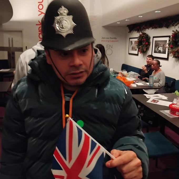 A Share student wearing a police hat and holding a union jack flag.