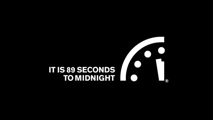 White text and image on a black background. Text: "It is 89 seconds to midnight." Image: The Doomsday Clock, a logo of the top-left corner of an analog clock with the minute and hour hands close to midnight.