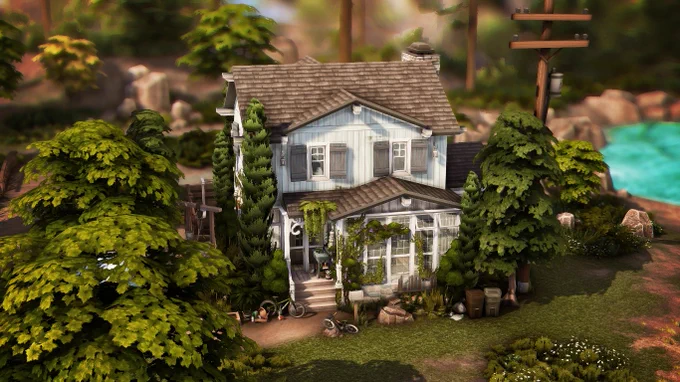 A front view of this worn and rustic house with blue shutters, ivy, and wisteria climbing the walls, all surrounded by lush trees.