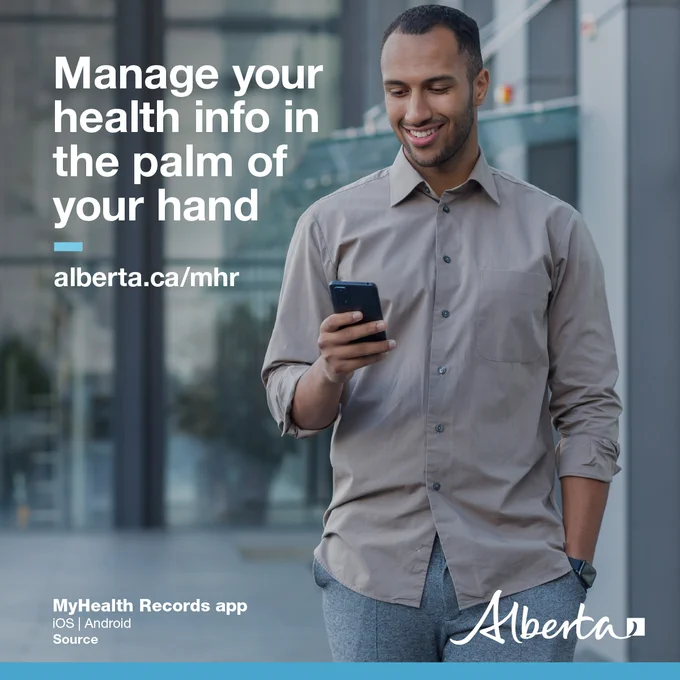 A person standing looking at their phone smiling. Headline reads Manage your health info in the palm of your hand: alberta.ca/myhealthrecords. The logo for the MyHealth Records app is in the bottom left corner. The Alberta Government logo is in the bottom right.