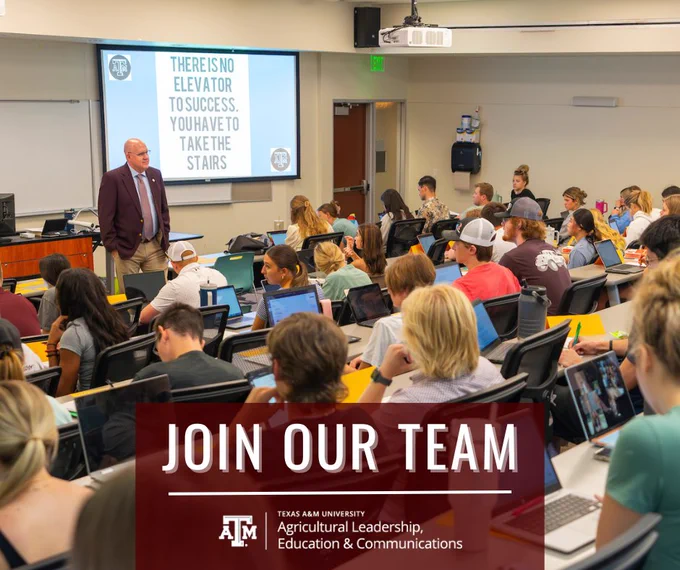 Texas A&M University lecture in progress with a professor standing at the front of the classroom and students using laptops while looking attentive. The classroom features a motivational quote on the wall and a banner promoting the Agricultural Leadership, Education & Communications team.