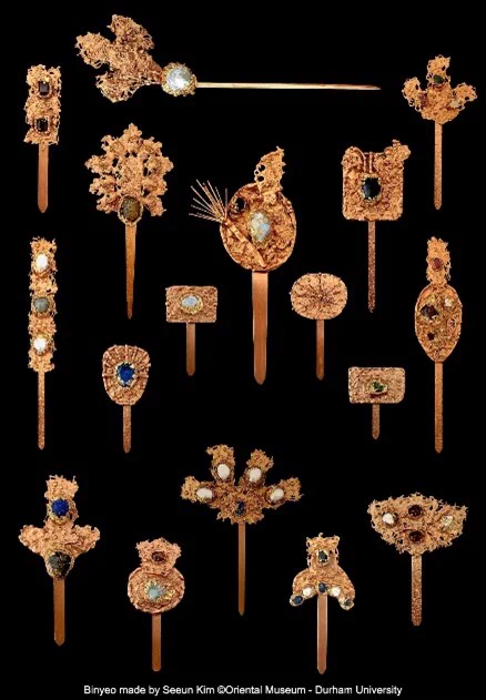 Close up details of gold coloured hair pins with jewel decoration, the pins have a thin, flat post and a round, ornate end. Each image shows details of the different hair pins.