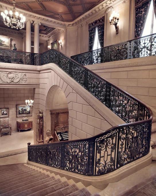 Marble staircase with a decorative iron railing