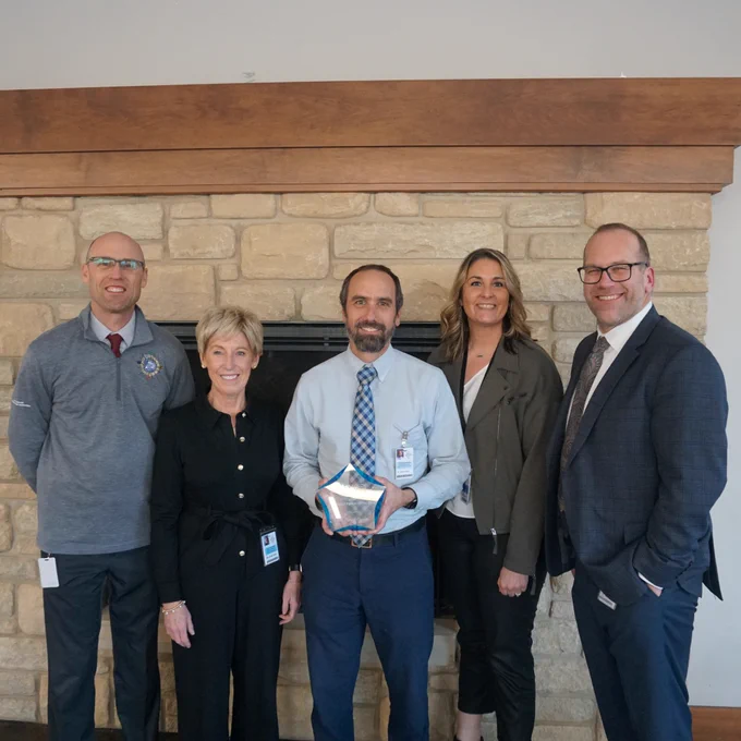 Dr. Brown, center, poses with his award alongside Fort Zumwalt colleagues