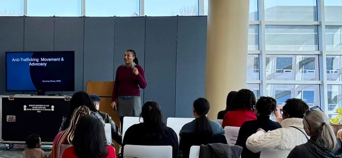 Woman speaking in front of audience
