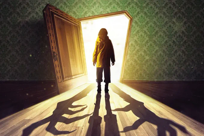 A photo showing a silhouette of a child in quirkily shaped door