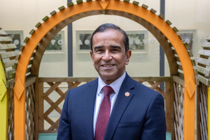 Jaydip Ray wearing a suit outside Sheffield Children's Hospital