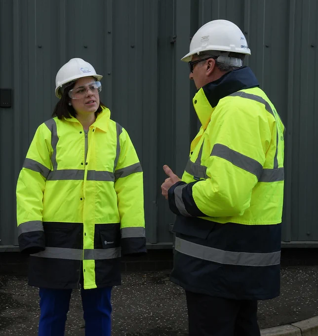Image of the Deputy First Minister in conversation with the CEO of Celtic Renewables on site at the biorefinery.