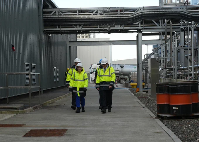 Image of a group of people wearing PPE walking through a biorefinery.