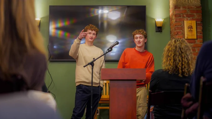 Taylor Watts points to an audience member with a question while Cody Watts looks on as the brothers host a Q&A as part of the author event at Village Books.