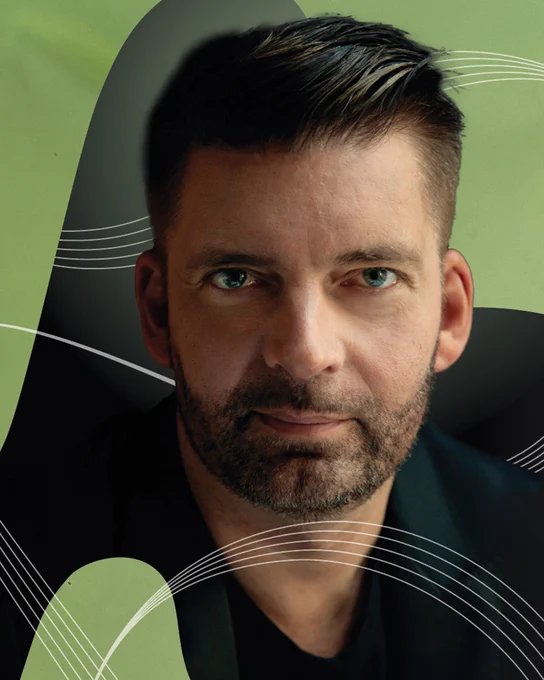 A close-up photo of Matthias Pintscher set against an abstract background of green and black.