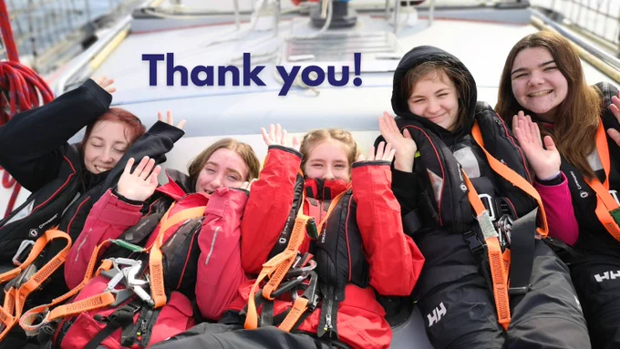 Image shows 5 young people lying on deck with their arms in the air. Above them, blue text reads: "thank you!"