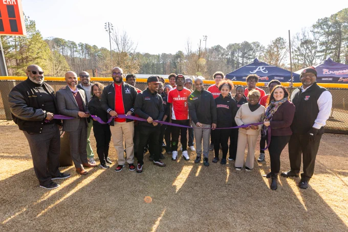 Representatives from Truist, Atlanta Braves Foundation, Atlanta Public Schools, and Therrell High School gather to cut the ribbon on the Braves Park Project