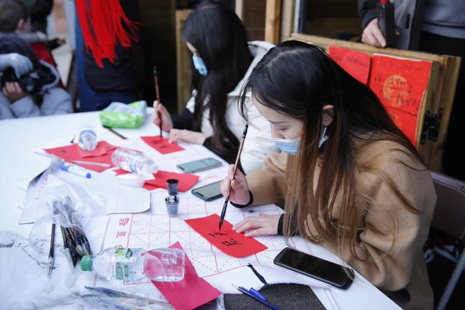 Two women writing Chinese calligraphy 