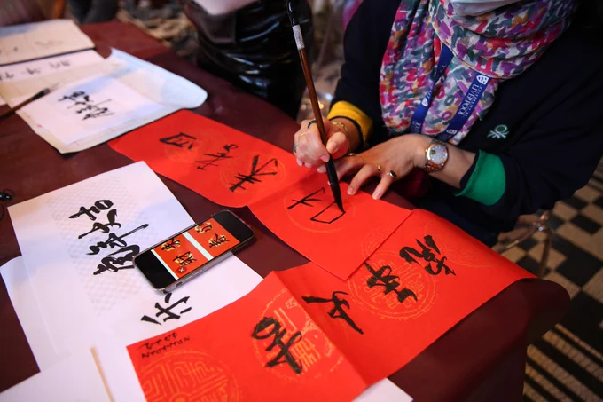 Woman writing Chinese calligraphy 