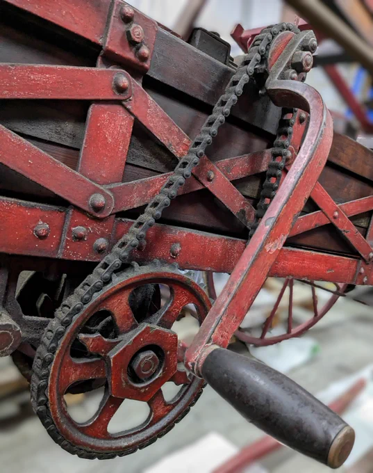 Close up of a section of a piece of fire brigade equipment made by Shand Mason, a manually operated chain-linked system.