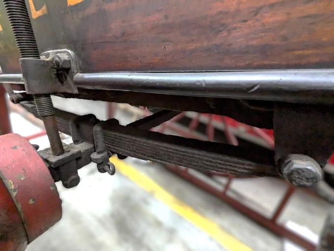 Close up the metal strips placed together and installed under a piece of fire brigade equipment made by Shand Mason to act as suspension when the equipment was moved by hand.