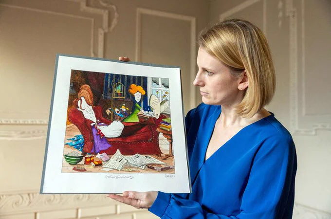 Image credit to Paul Sharp
Keeper of Research Collections, Laura Shanahan holding artist Annie West's work, 'If Maud Gonne had said Yes' - TCD MS 11727