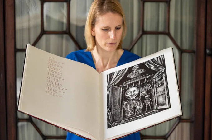 Image credit to Paul Sharp.
Laura Shanahan, Head of Trinity Research Collections holding a copy of A Modest Proposal by The Salvage Press – limited edition fine art book containing new interpretations of Jonathan Swift’s satirical essay with poems by Jessica Traynor and lithographs by David O'Kane. - OLS Papyrus Case 225
