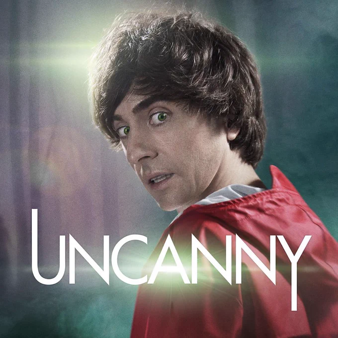 Image of Danny Robins wearing a red coat in a wood overlaid with an Uncanny logo
