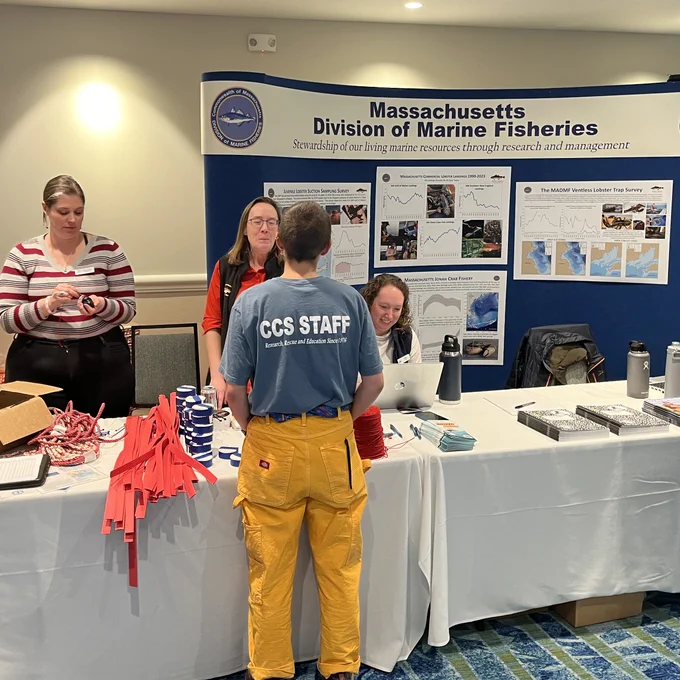 Division of Marine Fisheries staff talking to the public at a trade show.