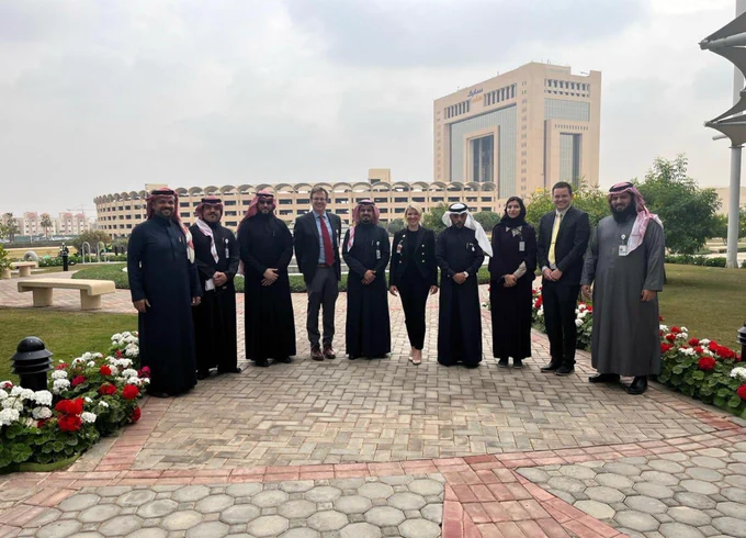 President  Amy Parsons posing for a picture with a group of people, Stene Verhulst and Dr. Allen Robinson in Saudi Arabia.