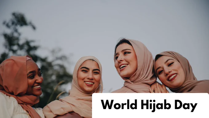 A photo of women in hijabs smiling.
