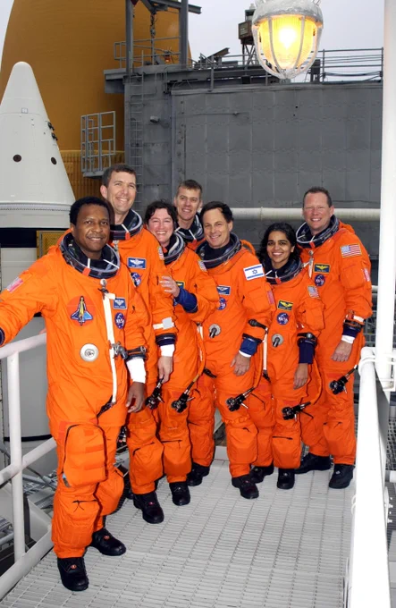 During Terminal Countdown Demonstration Test activities at the launch pad, the STS-107 crew paused for a group photo. From left are Payload Commander Michael Anderson, Commander Rick Husband, Mission Specialist Laurel Clark, Pilot William "Willie" McCool, and Mission Specialists Ilan Ramon, Kalpana Chawla and David Brown. Behind them is Space Shuttle Columbia. STS-107 was a mission devoted to research and included more than 80 experiments that studied Earth and space science, advanced technology development, and astronaut health and safety. Credit: NASA