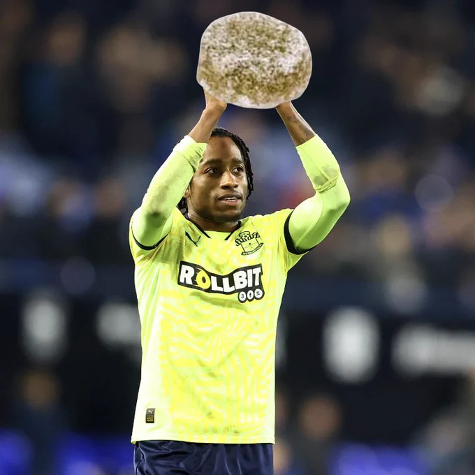 Kyle Walker-Peters at full time at Ipswich holds a giant green pastille above his head.