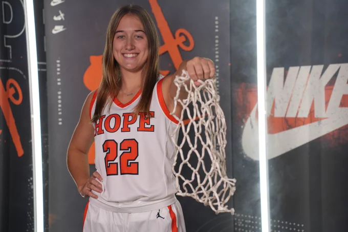 Terin Maynard holds a basketball net.