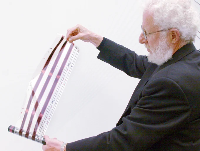 Alan Heeger unravelling a film of conductive polymer