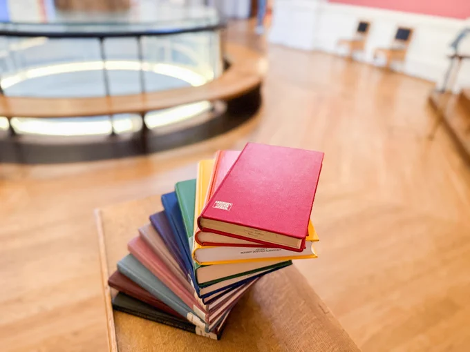 Multicoloured books in a rainbow arrangement. 