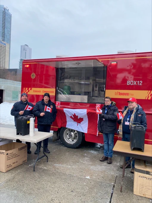 Toronto Firefighter's Box 12 Association volunteers providing hot chocolate for attendees.