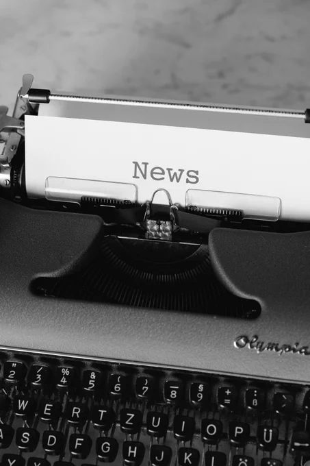 Black and white photo of typewriter, with word 'News'