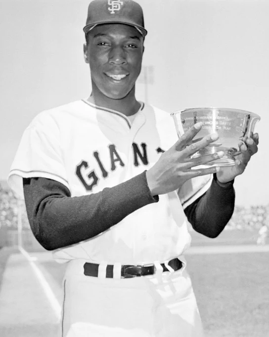 Willie McCovey poses at Candlestick Park on May 8, 1960 with the 1959 NL Rookie of the Year trophy. He is wearing a home Giants uniform.