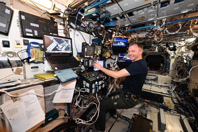 NASA astronaut Nick Hague at the robotics workstation on the International Space Station, where he flew the robotic arm during the U.S. spacewalk on Jan. 30, 2025. The 55-foot robotic Canadarm2 has seven different joints and two end-effectors, or hands, and is used to move entire modules, deploy science experiments and even transport spacewalking astronauts.