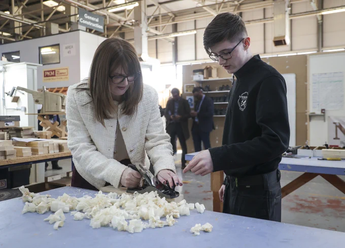Economy Minister Dr Caoimhe Archibald at Springvale Employment and Learning with Cormac Wilkinson, Skills for Life and Work level 1 carpentry and joinery student.