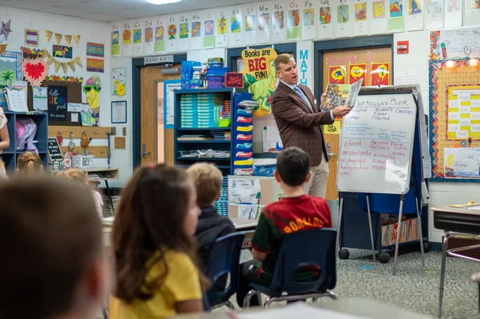FDOE staff reading to a group of elementary students.