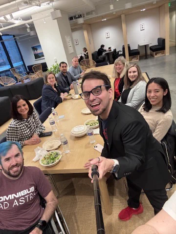 Image of 9 individuals around table. 