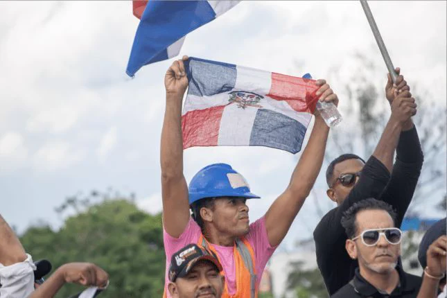 Santo Domingo Dominican Republic. Hundreds of people protest in the Plaza de la Bandera for more “rigorous” immigration control, courtesy of julio andres/Shutterstock.com.