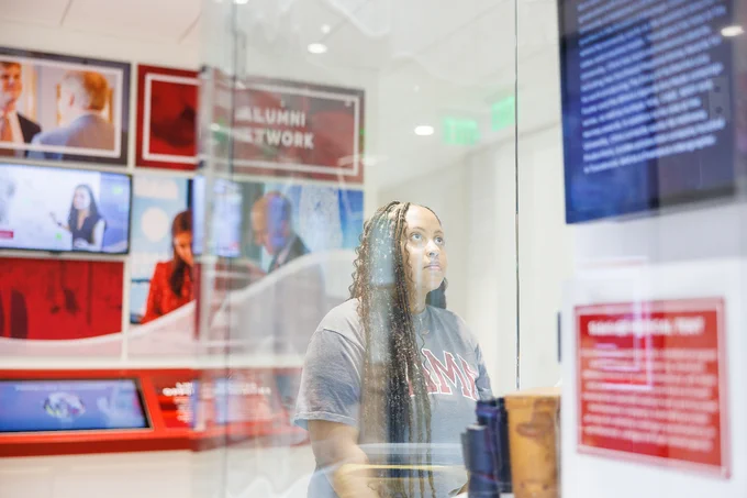 Individual looking at a display case in the Randall Welcome Center.