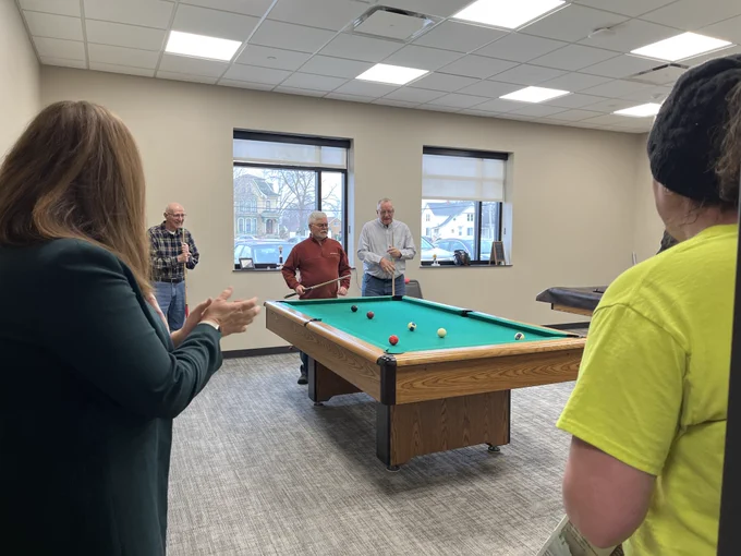 DOA Secretary Kathy Blumenfeld watches a friendly game of pool at the Waupun Community Center.