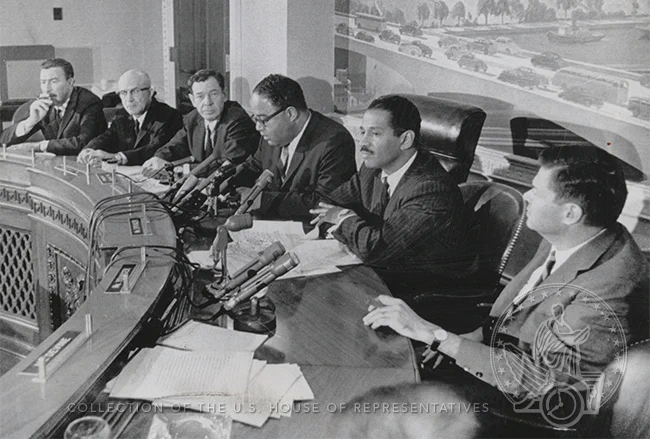 group of men sitting at a dais
